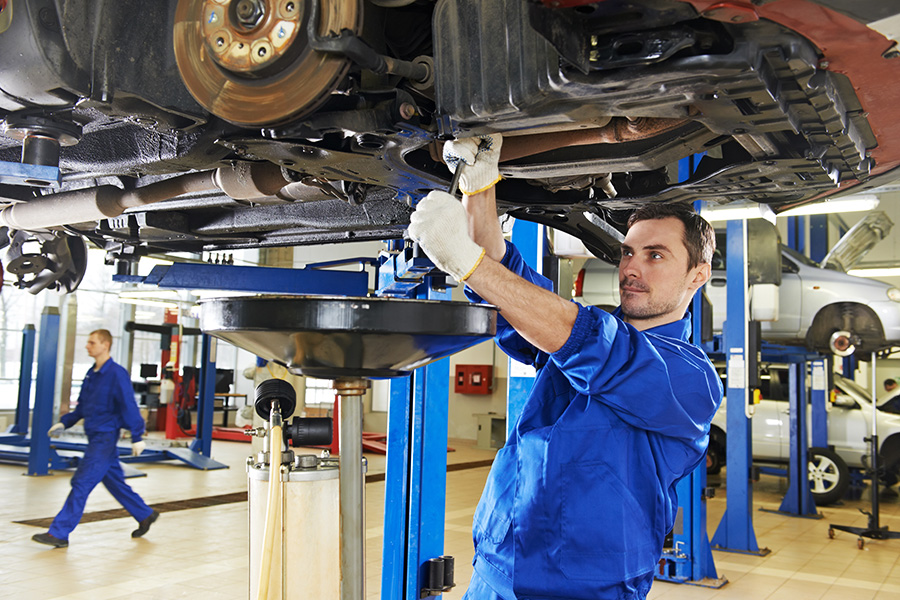 Certified technician performing professional GMC vehicle maintenance